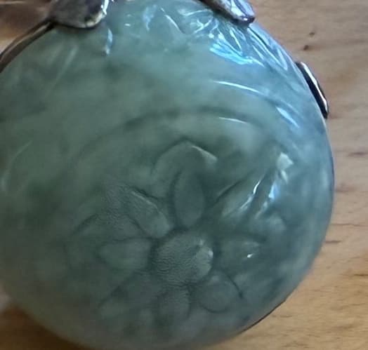 CARVED CELADON STONE SPHERE PENDANT WITH FLORAL MOTIF & SILVER-TONE CAP